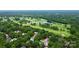 Scenic aerial view of property nestled among mature trees near golf course and community pool at 3304 Chilham Pl, Charlotte, NC 28226