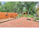 Brick patio featuring a wooden pergola, a fountain, and mature trees at 3304 Chilham Pl, Charlotte, NC 28226