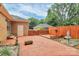 Brick patio featuring a small deck, a fountain, and mature landscaping at 3304 Chilham Pl, Charlotte, NC 28226