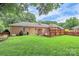 Sprawling backyard with wooden fence and lattice covered patio at 3304 Chilham Pl, Charlotte, NC 28226
