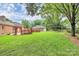 Expansive backyard with patio, fence, lush green lawn, and detached garage at 3304 Chilham Pl, Charlotte, NC 28226