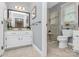 Bathroom featuring a double sink vanity, large mirror, walk in shower, and tile floors at 3304 Chilham Pl, Charlotte, NC 28226
