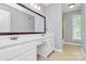 Bathroom featuring a double vanity, large mirror, and neutral finishes at 3304 Chilham Pl, Charlotte, NC 28226