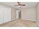 Bedroom with carpet, ceiling fan, and closet with paneled doors at 3304 Chilham Pl, Charlotte, NC 28226