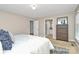 Bedroom with tan walls and carpet, window, a queen bed, and a chest of drawers at 3304 Chilham Pl, Charlotte, NC 28226