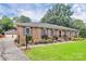 Charming brick home with lush lawn, manicured landscaping and detached two-car garage at 3304 Chilham Pl, Charlotte, NC 28226