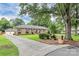 Traditional brick home with blue shutters, mature trees and extended driveway at 3304 Chilham Pl, Charlotte, NC 28226