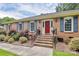 Inviting brick home featuring a red front door, blue shutters, and well-maintained landscaping at 3304 Chilham Pl, Charlotte, NC 28226