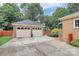 Detached two car garage with painted doors, concrete drive and brick veneer exterior at 3304 Chilham Pl, Charlotte, NC 28226