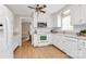 Clean white kitchen with modern appliances, laminate floors, and view into dining area at 3304 Chilham Pl, Charlotte, NC 28226
