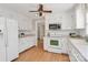 Charming kitchen featuring white cabinets, modern appliances, and a bright, airy feel at 3304 Chilham Pl, Charlotte, NC 28226