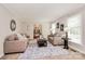 Bright living room featuring neutral paint, area rug, and entry to dining area at 3304 Chilham Pl, Charlotte, NC 28226