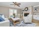Comfortable living room with fireplace, stylish seating, and a ceiling fan at 3304 Chilham Pl, Charlotte, NC 28226