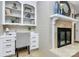 Dedicated office space with a desk, chair, and built-in shelving near the fireplace at 3304 Chilham Pl, Charlotte, NC 28226