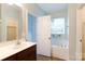 Bathroom featuring soaking tub, window, and vanity with plenty of storage at 405 Jenny Skip Ln, Rock Hill, SC 29732