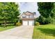 Charming two-story home features a stone facade, two-car garage, and well-manicured landscaping at 405 Jenny Skip Ln, Rock Hill, SC 29732