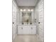 Bathroom featuring double sinks with white cabinets and modern lighting at 4059 Bass River Pkwy, Charlotte, NC 28217