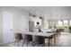 Dining area with modern table and chairs near a kitchen with white cabinets at 4059 Bass River Pkwy, Charlotte, NC 28217