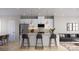 Modern kitchen with white cabinets, stainless steel appliances, and a large island at 4059 Bass River Pkwy, Charlotte, NC 28217