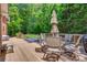 Backyard deck has a dining table and chairs, a hot tub and view of lush green space at 413 Farm Branch Dr, Fort Mill, SC 29715