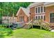 Multi-level deck with a hot tub and outdoor dining with a lush green yard at 413 Farm Branch Dr, Fort Mill, SC 29715