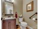 Traditional half bathroom featuring a wood vanity, granite countertop, and decorative wall art at 413 Farm Branch Dr, Fort Mill, SC 29715