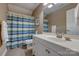 Bright bathroom with vanity sink, large mirror, toilet, and shower with striped curtain at 413 Farm Branch Dr, Fort Mill, SC 29715
