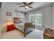 Bedroom featuring a wooden bed, neutral walls, and a large window letting in natural light at 413 Farm Branch Dr, Fort Mill, SC 29715