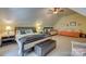 Spacious bedroom features neutral colors, a ceiling fan, and additional seating at 413 Farm Branch Dr, Fort Mill, SC 29715