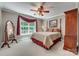 Cozy bedroom with a four-poster bed, large window, and elegant furnishings at 413 Farm Branch Dr, Fort Mill, SC 29715