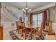 Well-lit dining room with hardwood floors, chandelier, and beautiful decorative rug at 413 Farm Branch Dr, Fort Mill, SC 29715