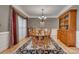 Formal dining room boasts hardwood floors, elegant chandelier, and natural light at 413 Farm Branch Dr, Fort Mill, SC 29715