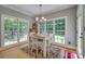 Dining room with chandelier, large windows overlooking the yard, and seating for four at 413 Farm Branch Dr, Fort Mill, SC 29715