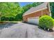 Long concrete driveway leads to a brick house and garage surrounded by trees at 413 Farm Branch Dr, Fort Mill, SC 29715