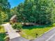 Charming brick home with a lush, landscaped front yard and a long driveway at 413 Farm Branch Dr, Fort Mill, SC 29715