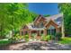 Traditional brick home boasts mature landscaping and a welcoming front porch at 413 Farm Branch Dr, Fort Mill, SC 29715