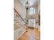 Grand two-story foyer features hardwood floors, chandelier, and elegant staircase at 413 Farm Branch Dr, Fort Mill, SC 29715