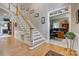 Inviting foyer with hardwood floors, staircase, and an open view into a home office at 413 Farm Branch Dr, Fort Mill, SC 29715