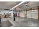 Large garage featuring two bays, a work area, and plenty of room for vehicles and storage at 413 Farm Branch Dr, Fort Mill, SC 29715