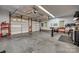 Spacious two-car garage with high ceilings, ample storage, and workspace area, ideal for hobbyists at 413 Farm Branch Dr, Fort Mill, SC 29715