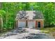 Detached brick two-car garage with automatic doors and a black entry door at 413 Farm Branch Dr, Fort Mill, SC 29715