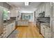 Open kitchen featuring white cabinets, granite countertops, stainless appliances, and a breakfast nook at 413 Farm Branch Dr, Fort Mill, SC 29715