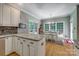 Kitchen with island, granite countertops, breakfast nook with a chandelier, and bright windows at 413 Farm Branch Dr, Fort Mill, SC 29715