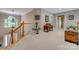 Open landing space featuring carpet floors and a decorative antique chest with staircase view at 413 Farm Branch Dr, Fort Mill, SC 29715