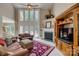 Spacious living room features a fireplace, tall windows, and comfortable seating at 413 Farm Branch Dr, Fort Mill, SC 29715