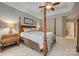 Spacious main bedroom with a four-poster bed, ceiling fan, and views of the yard at 413 Farm Branch Dr, Fort Mill, SC 29715