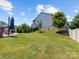 Expansive backyard featuring a paved patio, lush lawn, and manicured landscaping at 4261 Coachwhip Ave, Lancaster, SC 29720