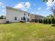 Spacious backyard featuring a well-maintained lawn, patio with seating, and a charming fire pit at 4261 Coachwhip Ave, Lancaster, SC 29720