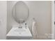 Bright bathroom with a modern vanity and a decorative oval mirror at 4261 Coachwhip Ave, Lancaster, SC 29720