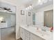 View of a bathroom with double sinks, white cabinets, and an adjoining bedroom at 4261 Coachwhip Ave, Lancaster, SC 29720
